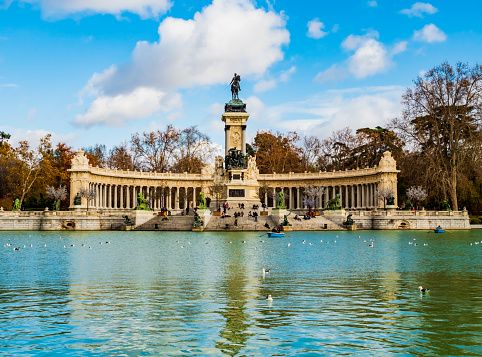 Lake, boats and the Alfonso XII monument in the Buen Retiro Park, the largest public garden in Madrid, Spain
