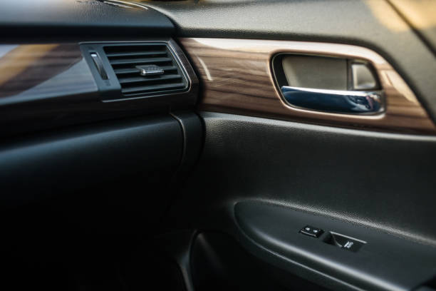 istock Car door control right panel. New car interior. Window lifters control. Armrest with setting adjustment button and blocking the opening and closing of doors. Car inside door chrome handle. Door trim. 1407706320