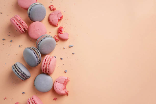 istock Pink and lilac macarons cookies on a pink background. 1407710425