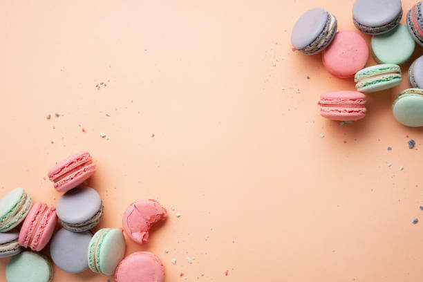 istock Pink, mint and lilac macarons cookies on a pink background. 1407710534