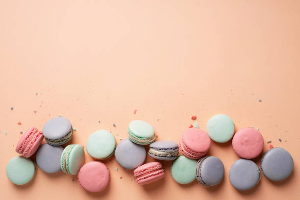 istock Pink, mint and lilac macarons cookies on a pink background. 1407710535