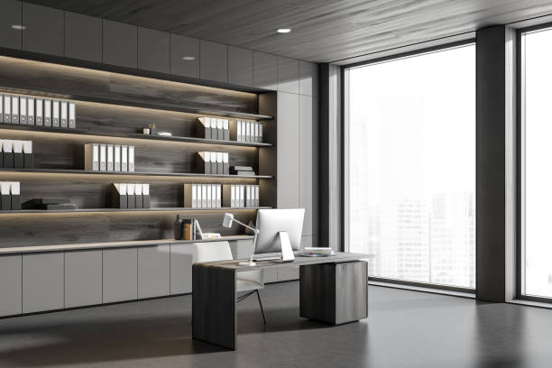istock Office interior with table and computer, shelf with folders and panoramic window 1407710750