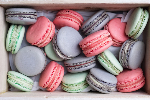 Pink, lilac and mint macaron cookies in the box.