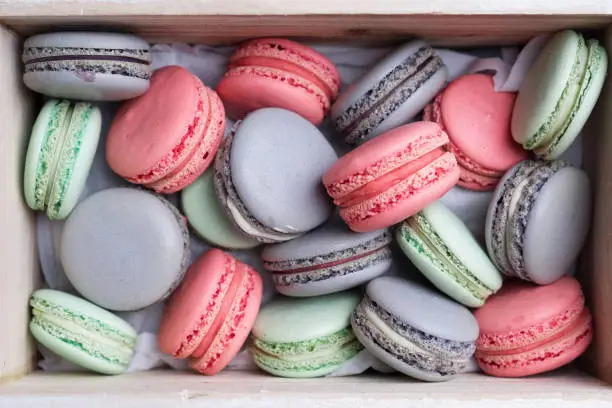 Pink, lilac and mint macaron cookies in the box.