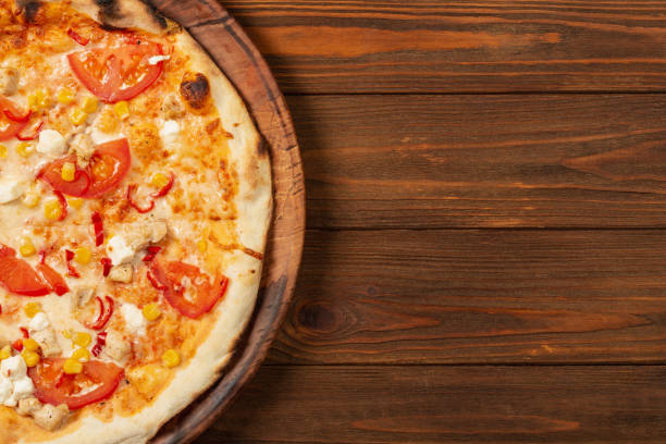 istock Pizza on wooden background, top view, flat lay 1407711212