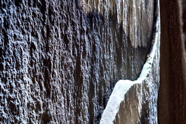 istock Sandstone slab on a vertical cleft surface with arched break edge, abstract graphic impression. 1407711822