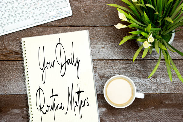 istock Your Daily Routine Matters concept for practice of regularly with milk coffee cup and lilies flowers pot and keyboard on wood table 1407712111
