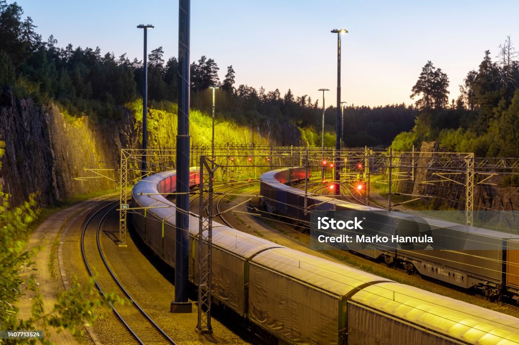 Cargo train junction during the sunset. Helsinki / Finland - JULY 5, 2022: Cargo train junction during the sunset. Train - Vehicle Stock Photo