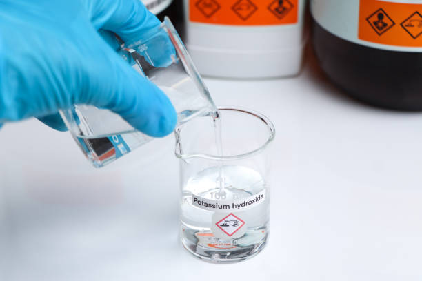 istock potassium hydroxide in glass, chemical in the laboratory 1407713812