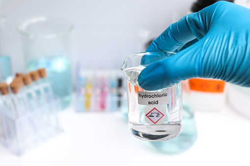Hydrochloric acid in glass, chemical in the laboratory and industry