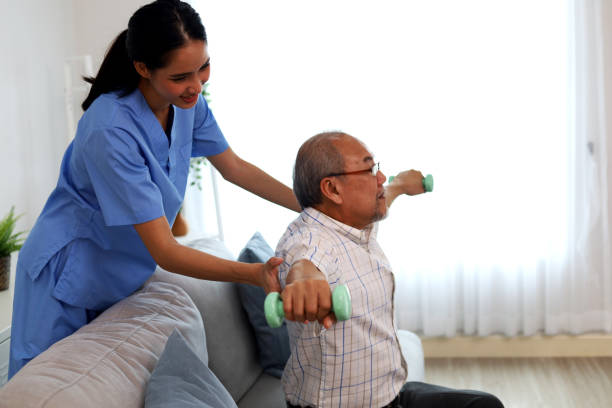 Happiness senior man physical therapy with a nurse. stock photo