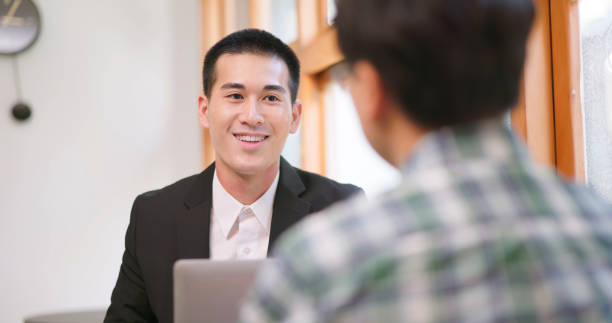 mortgage broker smiling while talking to a client