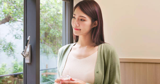 istock woman drinking water 1407715958