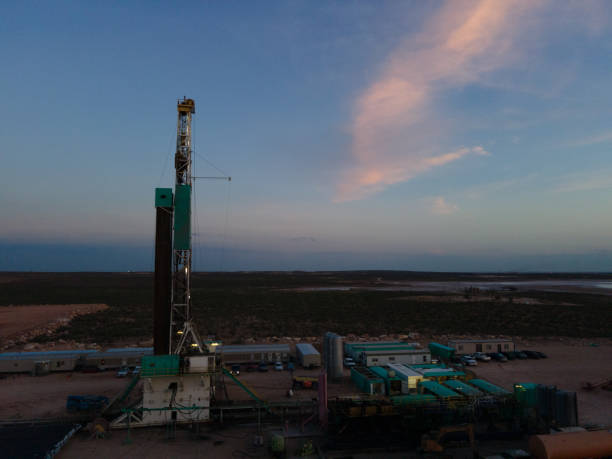 istock Fracking Drilling Rig Creating Gas or Oil Well Silhouetted at Dusk Under a Dramatic Sunset Sky 1407716561