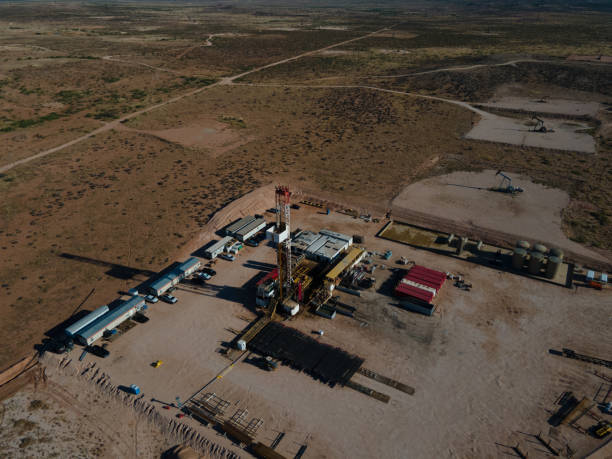 istock Fracking Drilling Rig Creating Gas or Oil Well Silhouetted at Dusk Under a Dramatic Sunset Sky 1407716578
