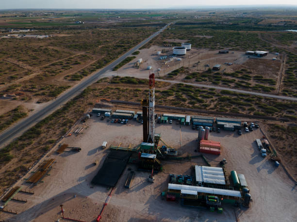 istock Fracking Drilling Rig Creating Gas or Oil Well Silhouetted at Dusk Under a Dramatic Sunset Sky 1407717124