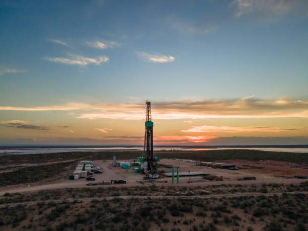 istock Fracking Drilling Rig Creating Gas or Oil Well Silhouetted at Dusk Under a Dramatic Sunset Sky 1407717403