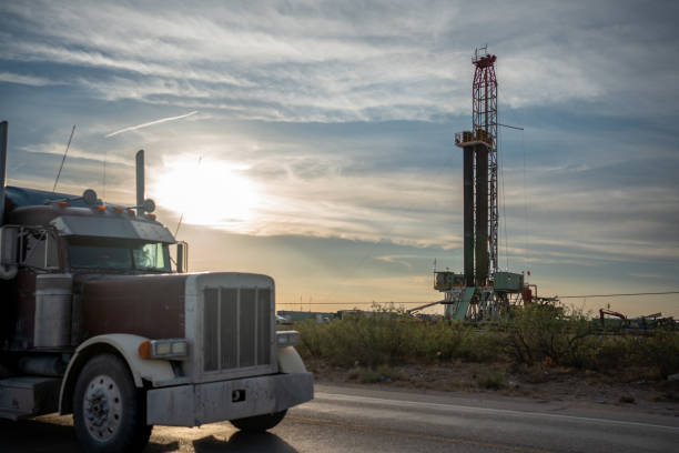 istock Fracking Drilling Rig Creating Gas or Oil Well Silhouetted at Dusk Under a Dramatic Sunset Sky 1407717545