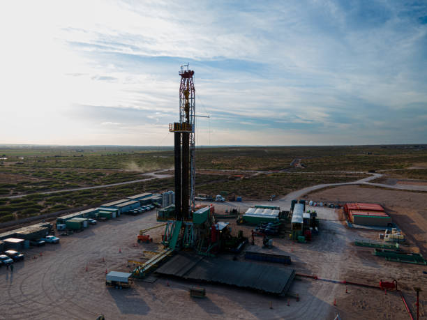 istock Fracking Drilling Rig Creating Gas or Oil Well Silhouetted at Dusk Under a Dramatic Sunset Sky 1407717556