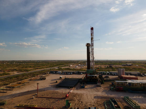 istock Fracking Drilling Rig Creating Gas or Oil Well Silhouetted at Dusk Under a Dramatic Sunset Sky 1407717584