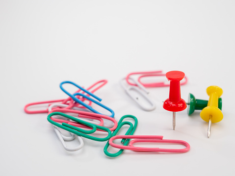 Set of colored paper clips and thumbtacks. Buttons and paperclips.