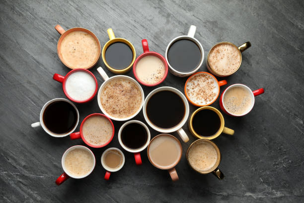 istock Many cups of different coffees on slate table, flat lay 1407720998
