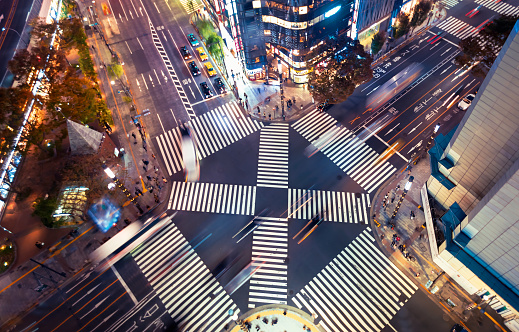TOKYO, JAPAN -MAY 15, 2020: Traffic and people cross a busy intersection in Ginza, Tokyo