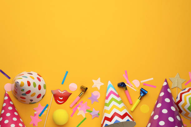 istock Flat lay composition with party hats and other festive items on orange background. Space for text 1407721600