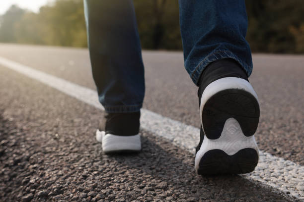 istock Man going along road, closeup of legs 1407722772