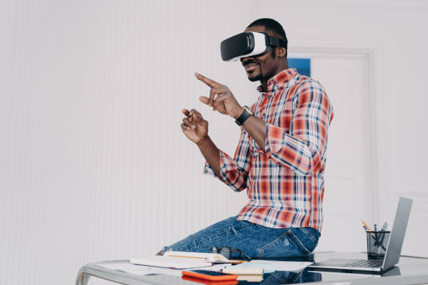 istock African american student in vr glasses at home. Young businessman has remote virtual study. 1407723617