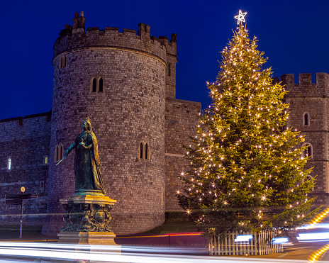 Windsor, UK - November 28th 2021: A beautifully illuminated Christmas tree outisde the historic Windsor Castle in Windsor, Berkshire, UK.