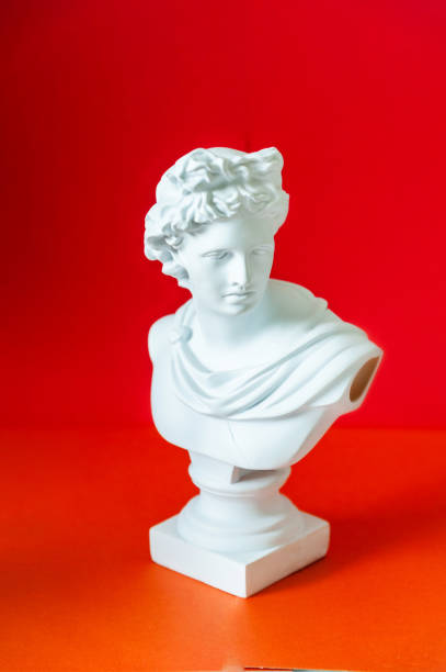 istock plaster bust of Apollo on a red background 1407724850