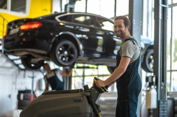 istock A service man working on a car in the garage 1407725038
