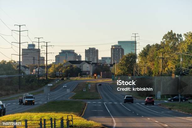 Reston Northern Virginia Town Center Office Building Architecture In Sunrise Morning View Of Cityscape Skyline And Street Road With Traffic Light And Cars Stock Photo - Download Image Now