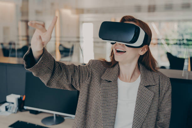 istock Excited female project manager reviewing virtual reality game while working in office 1407725899