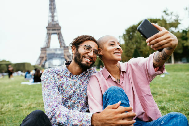 istock Multi ethnic couple near Eiffel tower taking selfie 1407727152