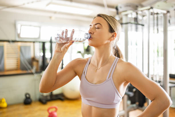istock Woman at gym hydrating 1407727366