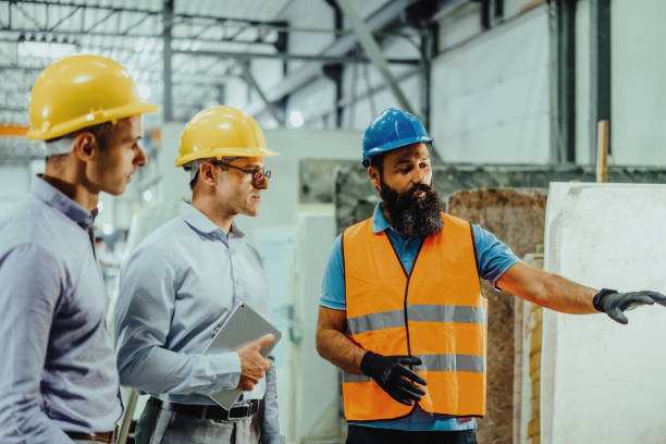 istock Employees and engineers in industry hall, discussing together 1407729591