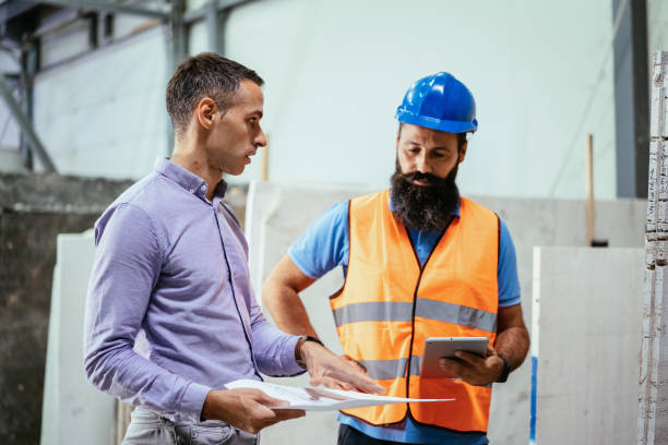 istock Employees and engineers in industry hall, discussing together 1407729596