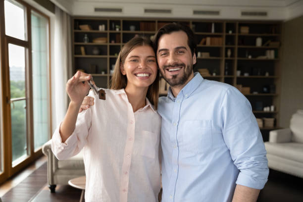 istock Homeowners couple holding keys bunch feeling happy at relocation day 1407729983