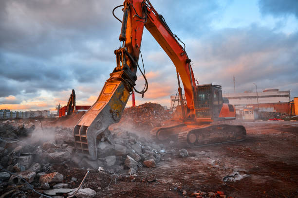 istock Excavator with concrete crusher on rig at demolition site 1407730946