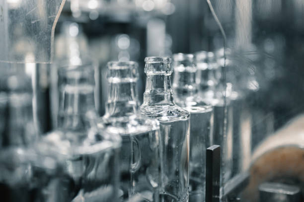 istock Row of glass bottles to fill with expensive alcohol drinks 1407730948
