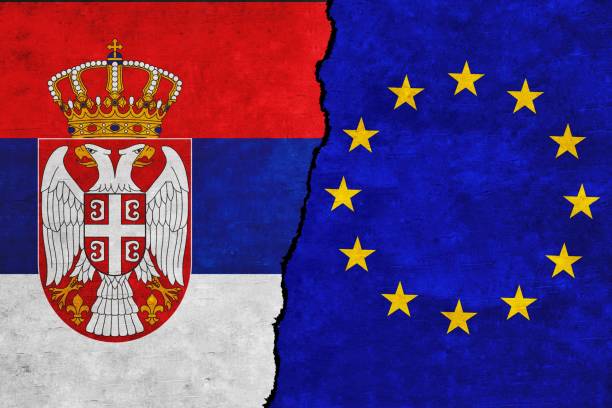 istock Serbia and European Union painted flags on a wall with a crack 1407731085