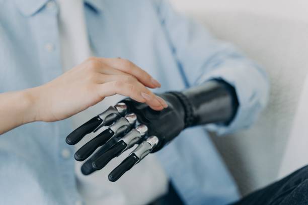 istock Hands of handicapped girl setting up her bionic arm and pressing buttons. Robotic bionic prosthesis. 1407731896