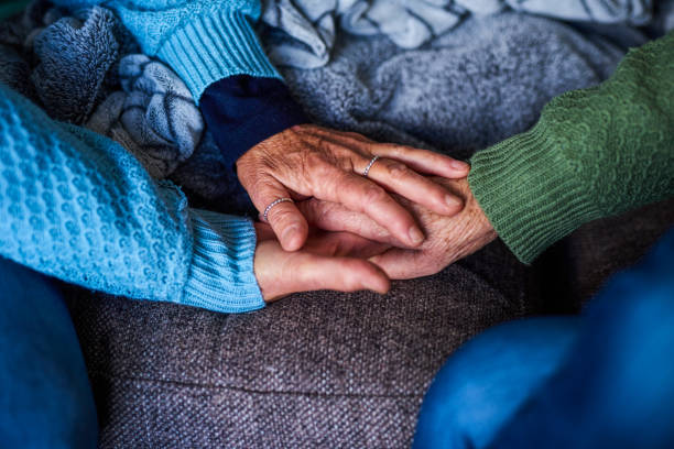 istock Hands of two older women in a caring embrace 1407731987