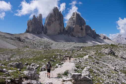 Trentino-Alto Adige, Italy - June 30, 2022: Hikers and mountain landscape with the Three Peaks of Lavaredo in the Dolomites