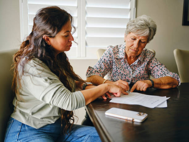Woman Helping a Senior Wtih Documents stock photo