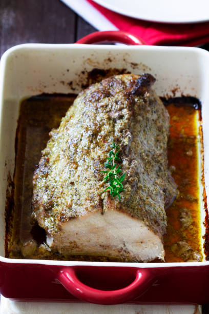 istock Pork loin baked with herbs, served in a baking dish. Rustic style. 1407737095