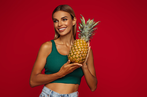 Portrait of girl holding a pineapple
