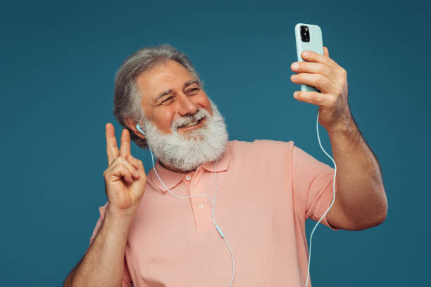 istock Portrait of emotional old man using smart phone 1407737382